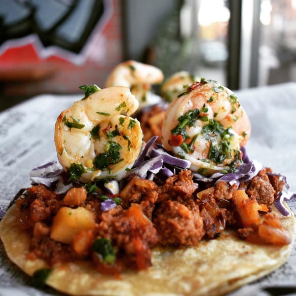 Shrimp and chorizo taco from Chicago Taco Authority, garnished with red cabbage and cilantro.